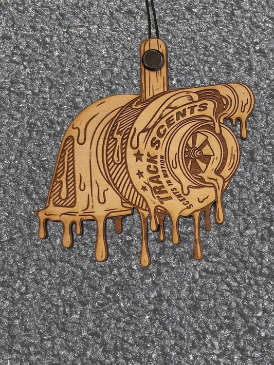 Wooden turbo-shaped ornament with 'Trackscents' branding on a gray background